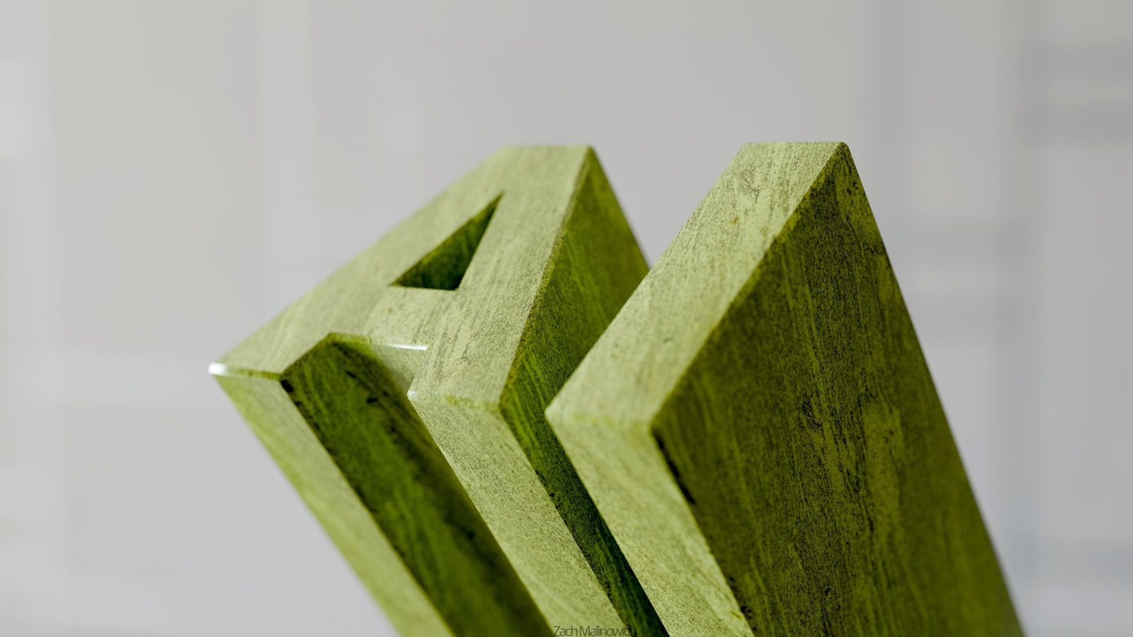 Green wooden letters spelling out "am"