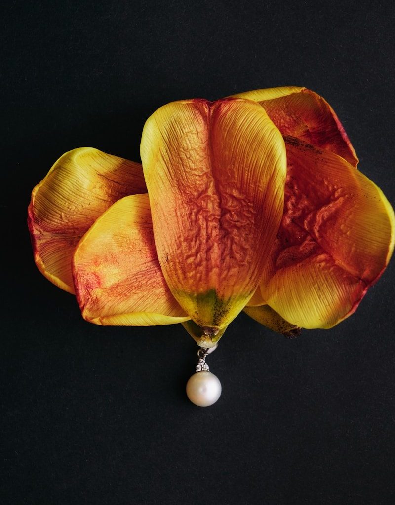 Dried petals with a pearl pendant.